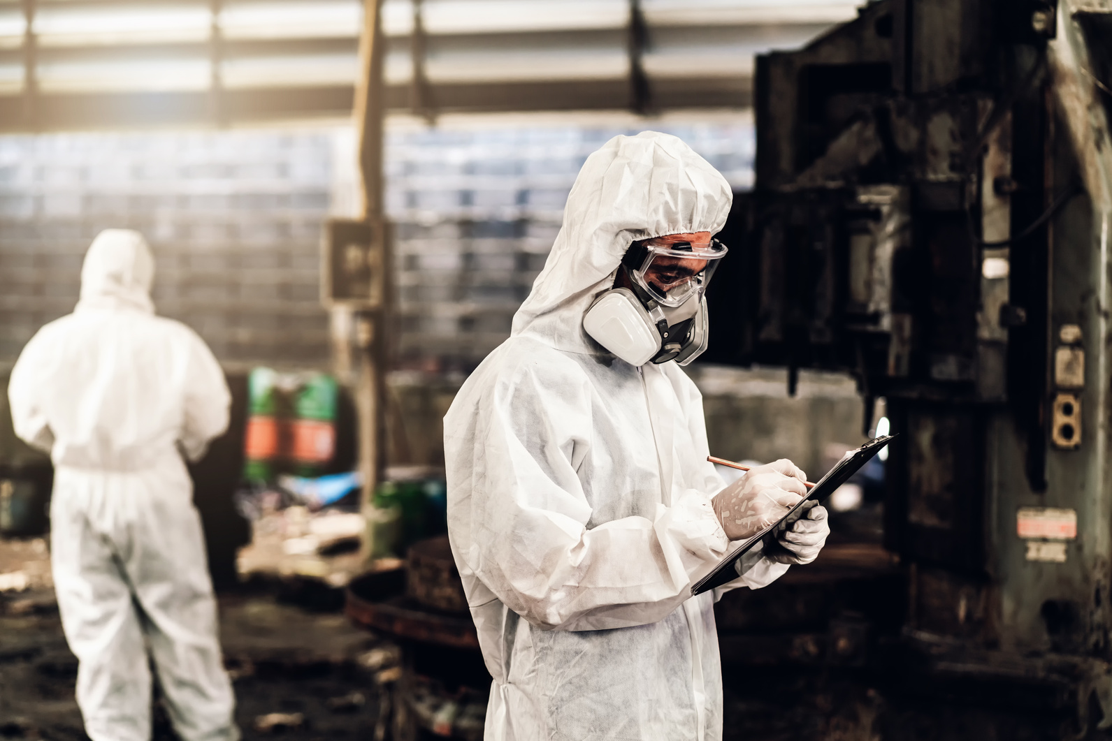 Scientist wear Chemical protection suit check danger chemical, working at dangerous zone. Healthcare workers wearing hazmat suits working together to control an outbreak